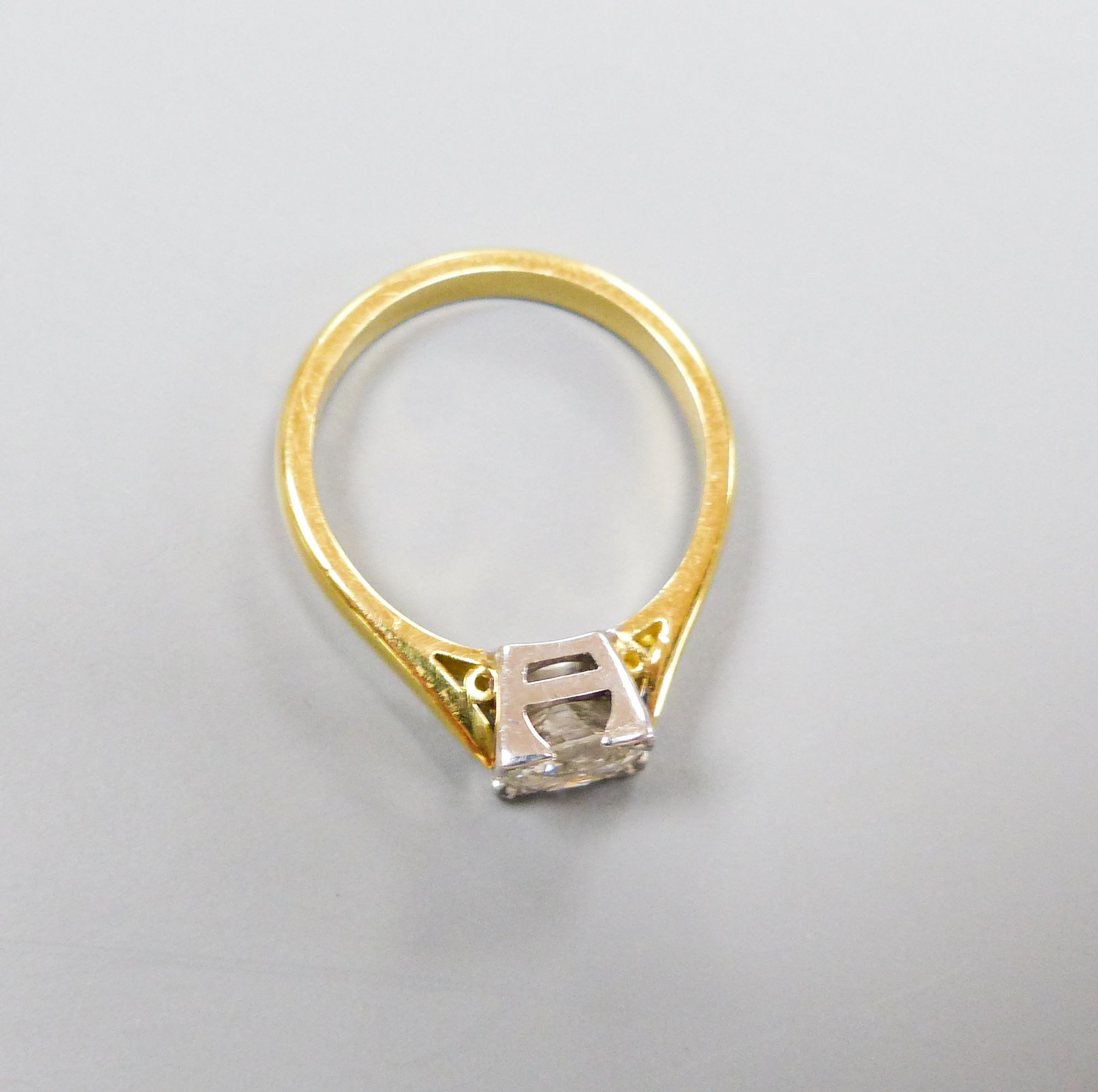 A modern 18ct gild and solitaire diamond ring, size M, gross weight 4.3 grams